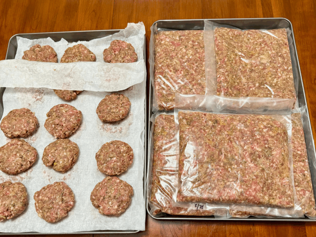 batch prepped ground meat & seasonings formed into homemade burger patties & vacuum sealed flat packs ready for the freezer