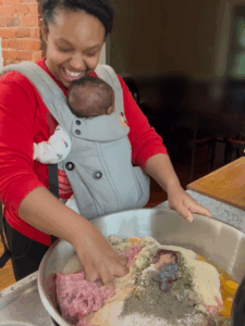 brown girl mixing meat and spices in large bowl while laughing