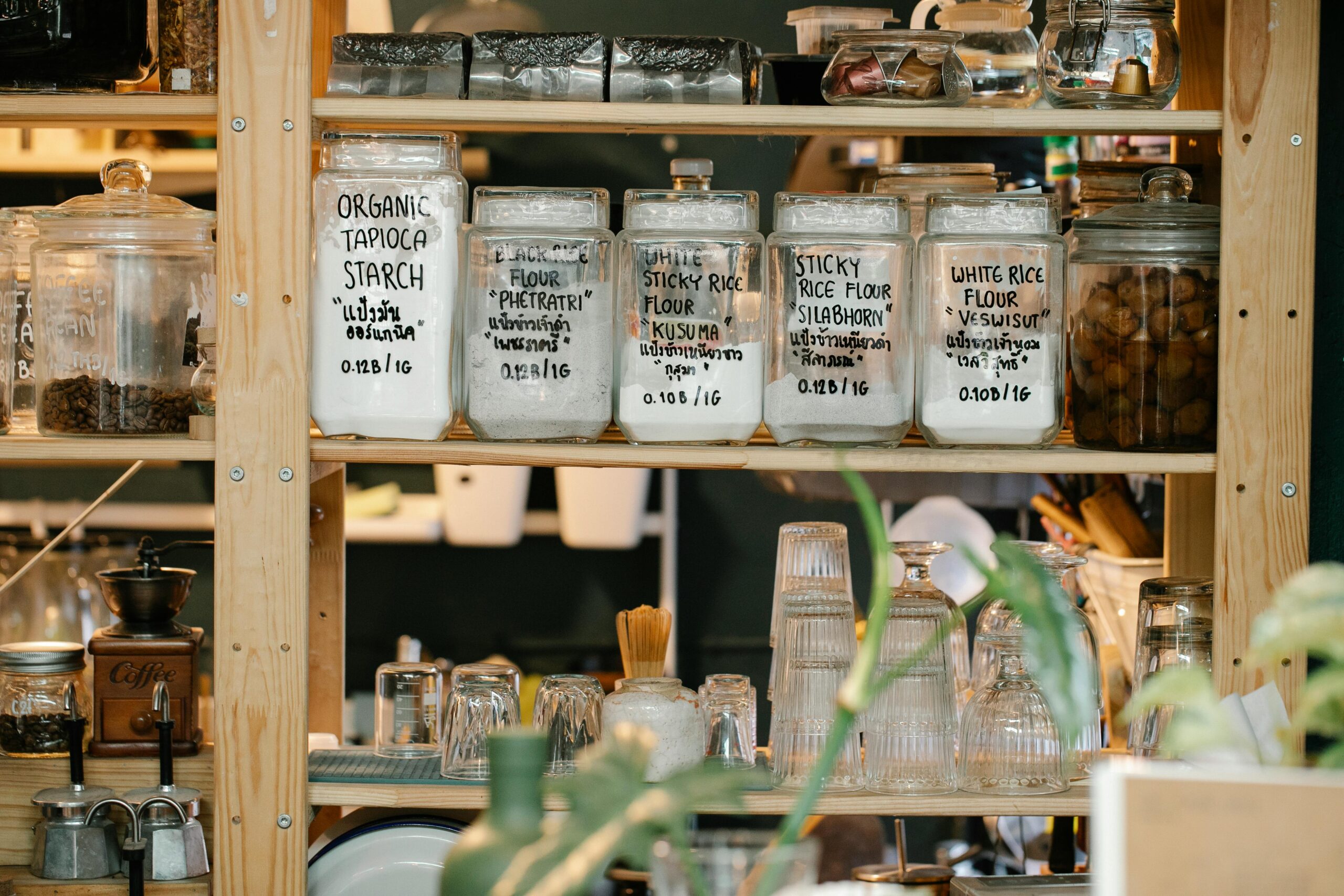 shelving houses long-term pantry storage foods like flours in glass containers making the kitchen management systems like resource management easier
