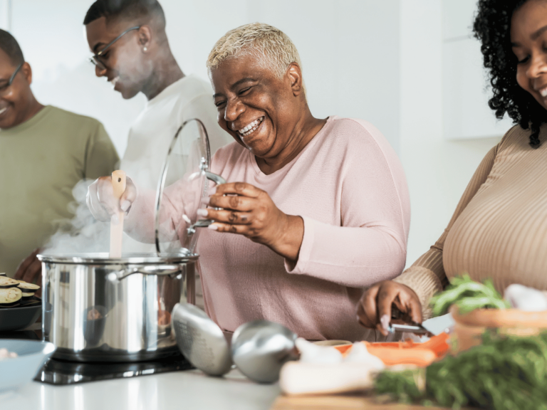 family members participating in family project ideas in the kitchen by cooking together